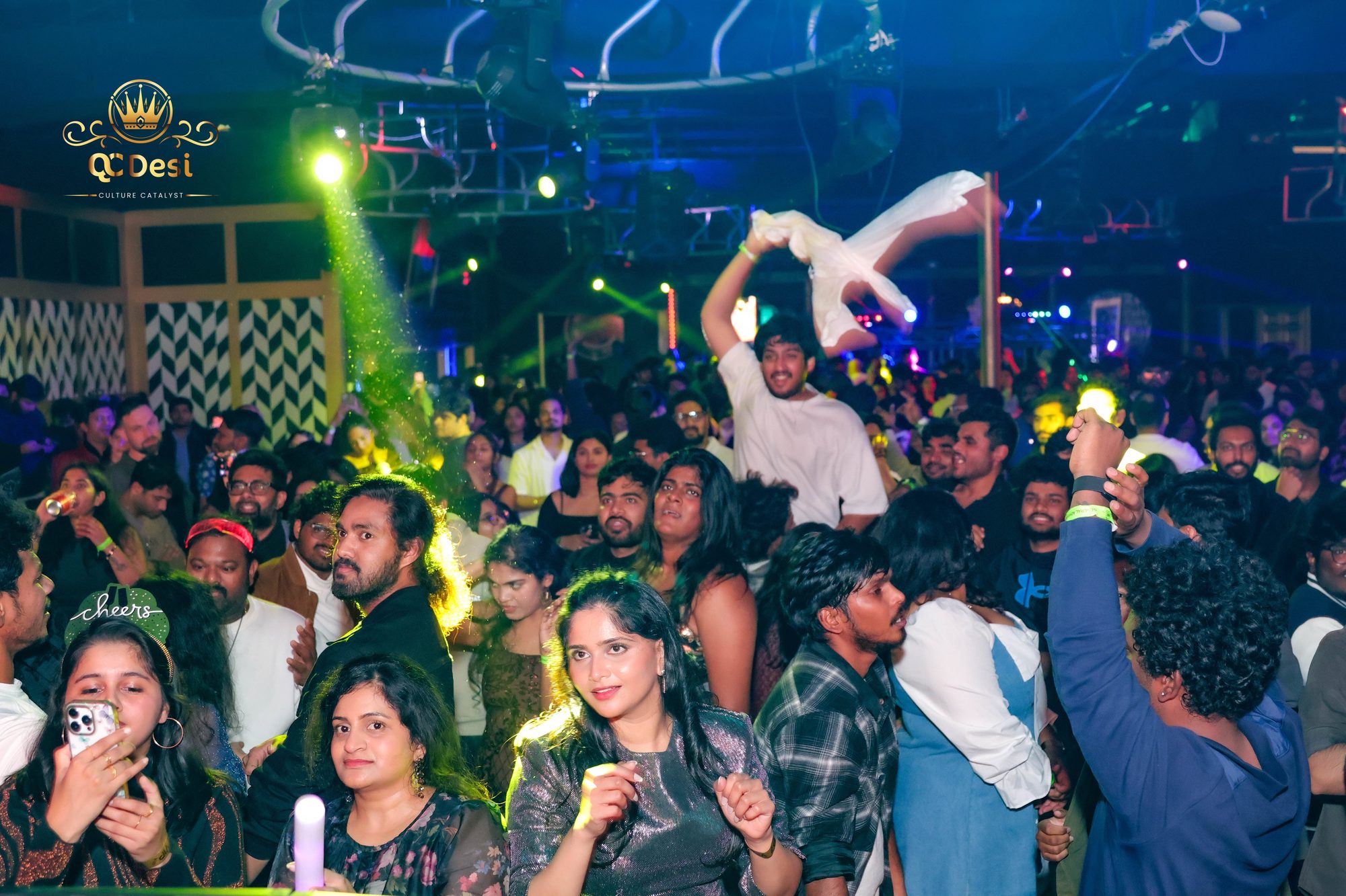 Packed dance floor with hands in the air at QCDesi New Year's Eve