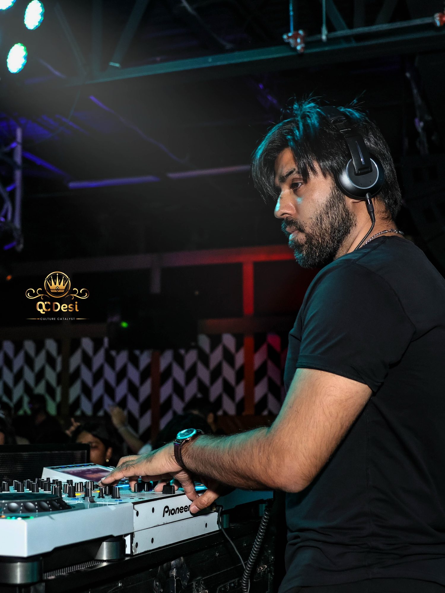 DJ on the decks at QCDesi New Year's Eve