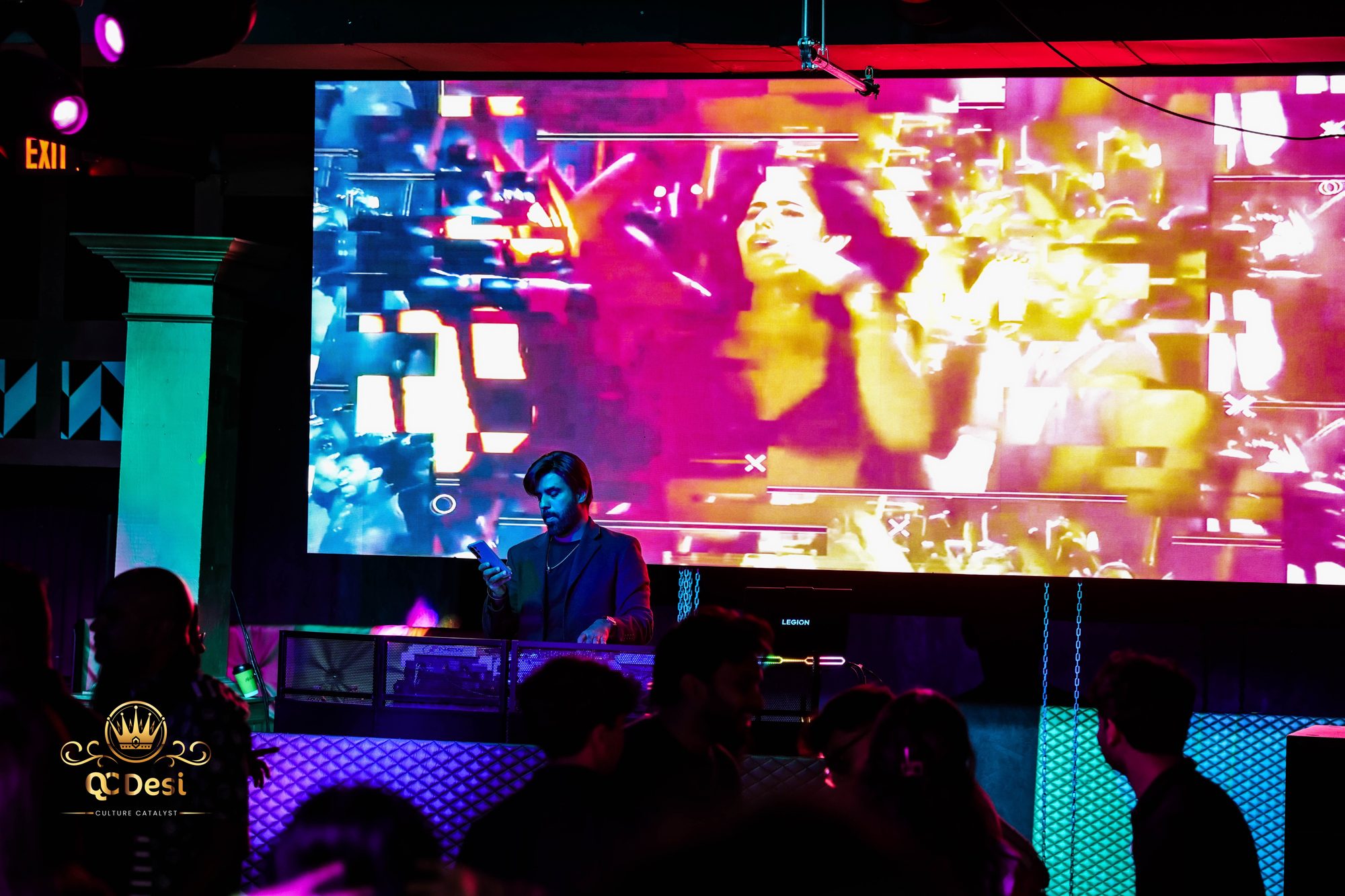 DJ booth under a giant Bollywood video wall