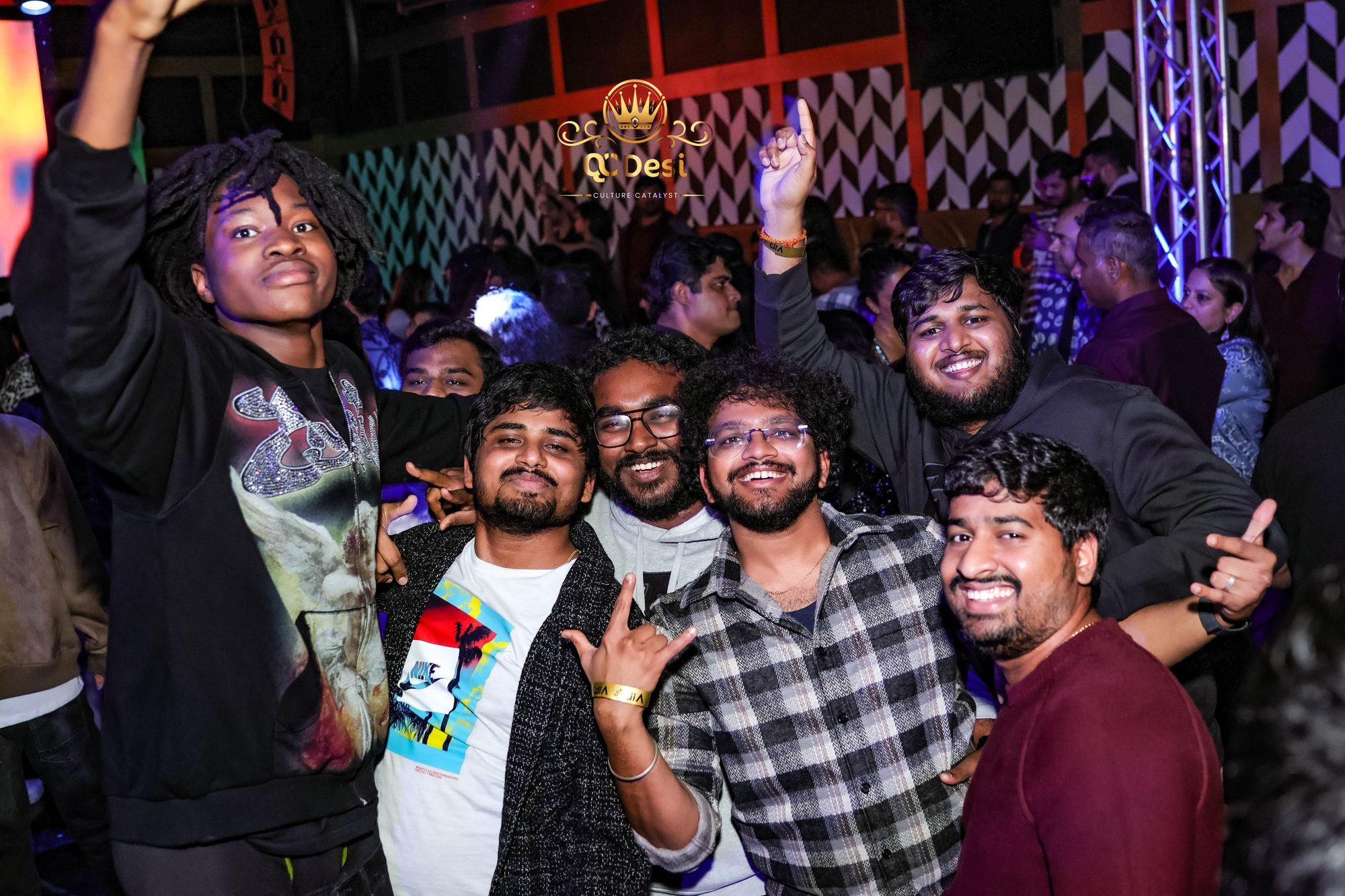 Friends throwing their hands up on the dance floor